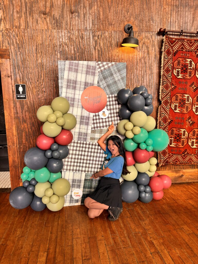 Balloon arch and photo backdrop set up for the family block at Flannel Fest, Boone & Crockett